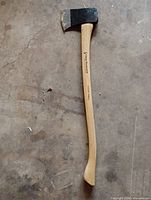 Full view showing hickory handle and black forged head
