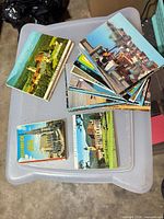 Stacks of Austrian vintage postcards on plastic bin lid