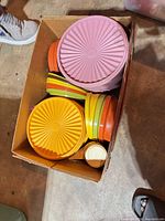 Box containing assorted Tupperware lids, plates and small containers