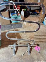 Full view of freestanding chrome S-bar towel warmer with power cord