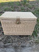 Front view of rectangular wicker-seagrass basket showing latch and woven texture