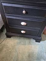 front view showing three drawers with hardware