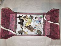 Open pink marbled box showing all figurines