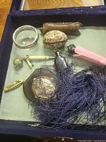 Top view of all items inside blue velvet-lined box
