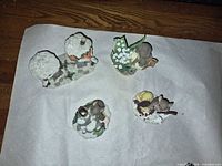 Group of four mouse figurines laid on paper backing
