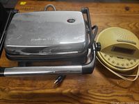 Front view of closed Hamilton Beach grill with Homedics SoundSpa beside it
