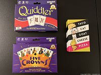 Front view of three card games: Quiddler Jr., Five Crowns, Taco Cat Goat Cheese Pizza
