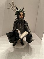 Front view of Black Peter figurine showing overall design and book