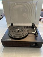 Record player front view with dust cover open