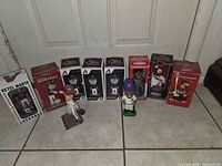 Group shot of all boxed and loose bobbleheads on floor