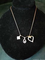 Entire necklace with three pendants on display bust