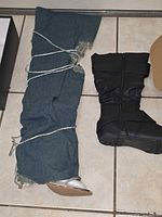 Denim thigh-high boot and black mid-calf boot side by side