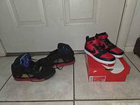 Both pairs of sneakers side by side; Court Borough Mid 2 on box, Jordan 5 on floor