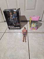 Group shot of Abbott & Costello boxed figures, Furby boxed toy, and loose Ken doll