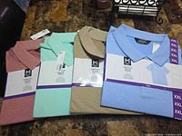 All four packaged polo shirts in assorted colors