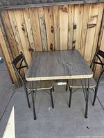 Full view of square table with two chairs