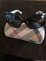 Front view of Burberry cat-eye sunglasses on plaid case