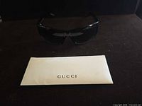 Sunglasses and Gucci envelope displayed