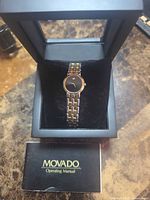 Watch in open Movado display box with manual visible