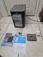 Brio countertop water cooler with all accessories and booklets laid out