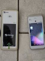 Clover C403 reader and powered-on Pax A920 terminal side by side