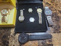 Overview of all seven watches on table