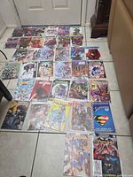Overview of all comics laid out on floor, shows quantity and variety