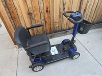 Side view of E-Wheels EW-M50 scooter showing seat, basket and overall condition