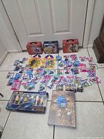 Full lot overview on floor showing all sealed mini figures, Star Trek PEZ set, M&M puzzle box and three lunch tins