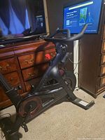 Full view of Peloton Bike+ beside dresser