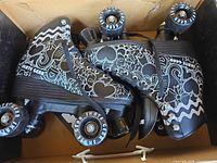 Top view of both skates in box showing pattern and wheels