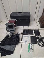 Full kit laid out: camera, case, holders, cloth, accessories
