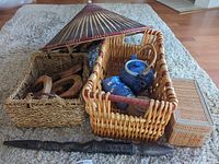 Overall lot view showing baskets, teapot set, parasol, staff, wooden rings