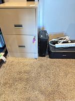 Cabinet, shredder, printer, power accessories visible