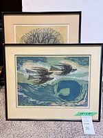 Front view of framed bird print with abstract marine background