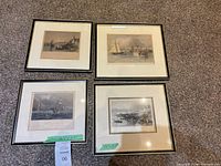 Overview of four framed nautical prints on carpet