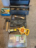 Overview of all items: toolbox, socket set, hammers, hatchet, measuring tape, stud finder, glue gun box, hardware organizer