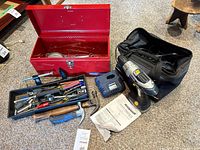 Overview of lot with red toolbox, cordless drill, charger, tool bag, tool tray and hammers