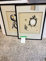 Both framed prints side by side showing size and frame condition