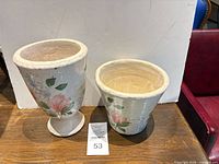 Both planters side by side showing relative sizes and decoration