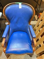 Top view of royal blue faux leather armchair showing seat, arms, wood frame