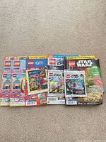 Group shot of all five sealed LEGO magazines with attached polybags