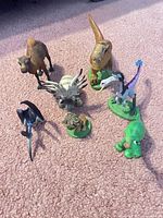 Group shot of seven figurines on carpet