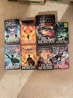 Eight Rick Riordan books laid out in two rows showing covers