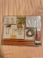 Front view of sealed Accessorize stationery set showing full contents in tray