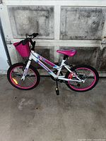 Side view of white and pink kids bicycle showing overall condition and features