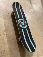 Top view of skateboard deck with Madd Gear Australia logo and stripes