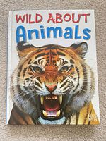 Front cover showing title Wild About Animals with tiger image