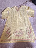 Full view of yellow embroidered kurta dress front