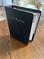 Closed binder titled "First Day Covers"